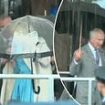 Moment King Charles snaps at an aide to help out after Queen Camilla struggled to get her coat on while battling wind and rain in Jersey