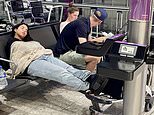Shattered families bed down at airports on what should be the first night of their summer holidays as travel chaos following global PC meltdown shows no sign of ending: Thousands of passengers have plans ruined by botched Windows update