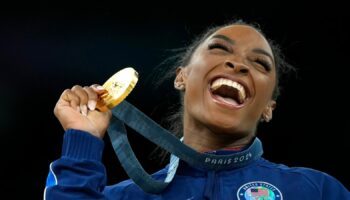 Simone Biles, of the United States, celebrates after winning the gold medal at the medal ceremony during the women's artistic gymnastics individual vault finals at Bercy Arena at the 2024 Summer Olympics, Saturday, Aug. 3, 2024, in Paris, France. (AP Photo/Francisco Seco)