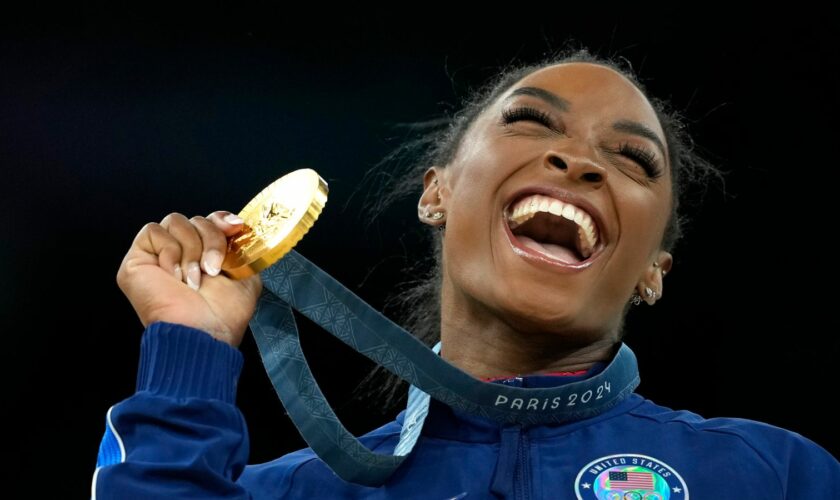 Simone Biles, of the United States, celebrates after winning the gold medal at the medal ceremony during the women's artistic gymnastics individual vault finals at Bercy Arena at the 2024 Summer Olympics, Saturday, Aug. 3, 2024, in Paris, France. (AP Photo/Francisco Seco)