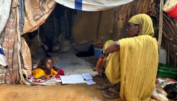 A displaced Sudanese woman rests inside a shelter at Zamzam camp, in North Darfur, Sudan, August 1, 2024. REUTERS/Mohamed Jamal Jebrel