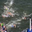 Athletes are swimming in the River Seine during the Men's Triathlon in Paris on July 31, 2024. The men's Olympic triathlon planned for the previous day has been postponed over concerns about water quality in the River Seine, where the swimming part of the race was scheduled to take place. ( The Yomiuri Shimbun via AP Images )