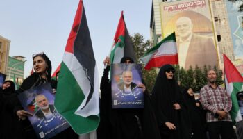 People in Tehran hold Palestinian flags as they attend an anti-Israel gathering following the killing of Hamas's leader Ismail Haniyeh. Pic: Reuters