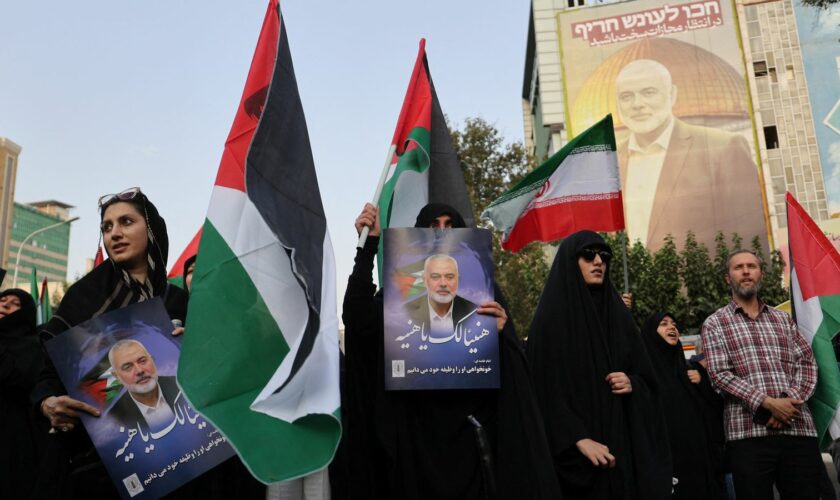 People in Tehran hold Palestinian flags as they attend an anti-Israel gathering following the killing of Hamas's leader Ismail Haniyeh. Pic: Reuters