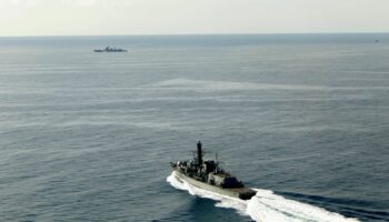 HMS Richmond (foreground) moves at speed to make contact with the Chinese destroyer Jiaozuo. Pic: Royal Navy