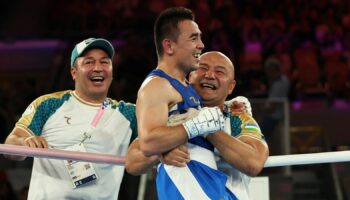 Paris 2024 Olympics - Boxing - Men's 51kg - Final - Roland-Garros Stadium, Paris, France - August 08, 2024. Hasanboy Dusmatov of Uzbekistan celebrates with coaching staff after winning against Billal Bennama of France. REUTERS/Maye-E Wong