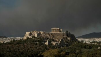 The Parthenon temple atop the Acropolis hill as smoke from a wildfire is seen, in Athens Greece, August 11, 2024. REUTERS/Elias Marcou TPX IMAGES OF THE DAY