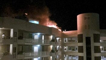 The fire burning on the DoubleTree Hotel after the helicopter crash. Pic: Reuters