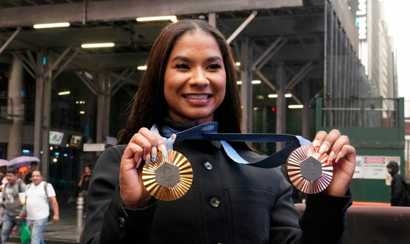 Jordan Chiles shows off her gold and bronze medals in New York. Pic: AP