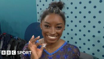 Simone Biles shows off her goat necklace