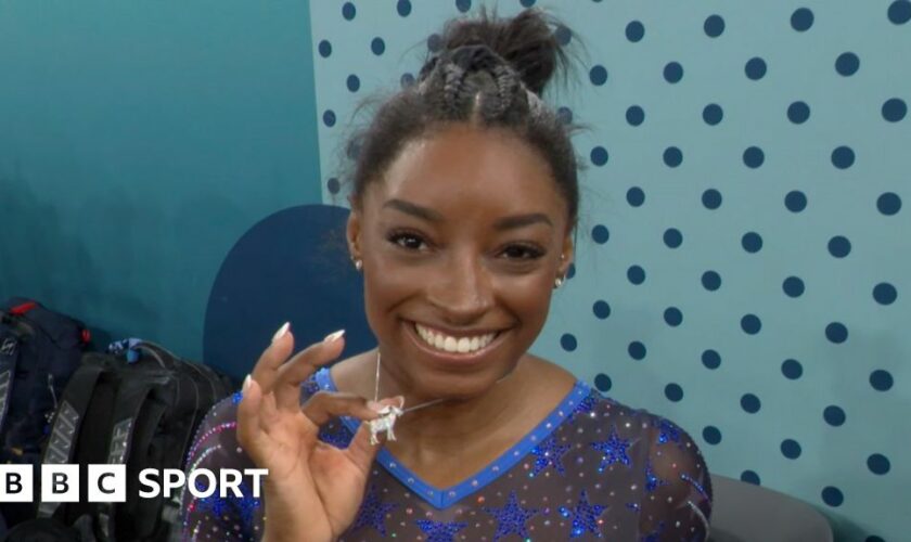 Simone Biles shows off her goat necklace