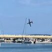 Plane crashes into the sea in front of horrified spectators at French air show, with rescue operation underway for pilot