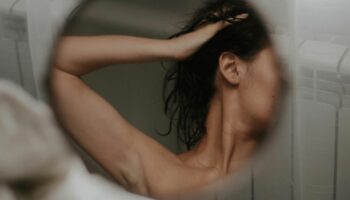 Affäre: Eine Frau ist schemenhaft in einem Spiegel zu sehen