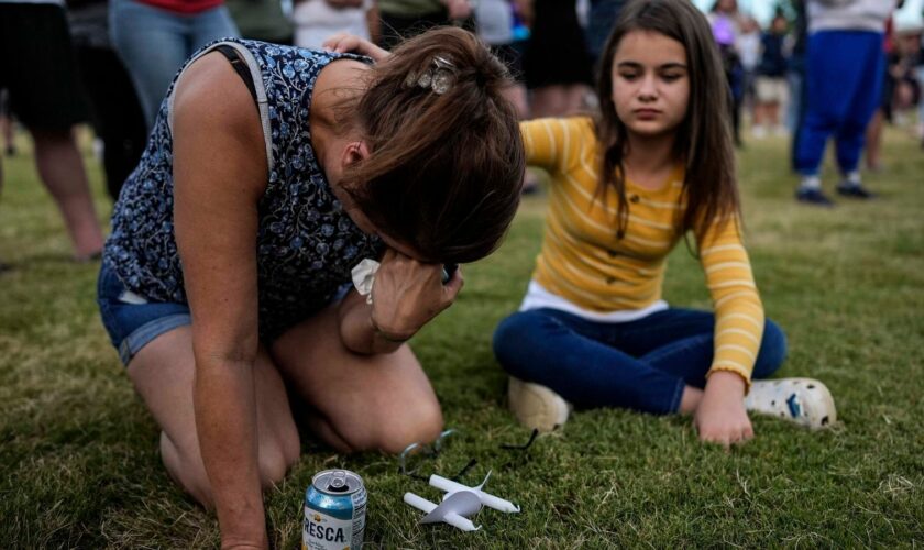 Brandy Rickaba and her daughter Emilie during a candlelight vigil for the victims of the school shooting. Pic: AP