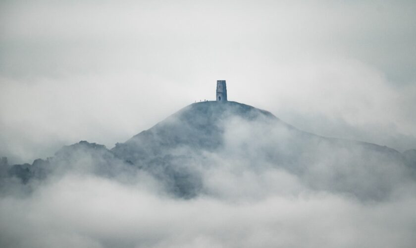 People gather on Glastonbury Tor after heavy rain over the Somerset Levels on Saturday. Pic: PA