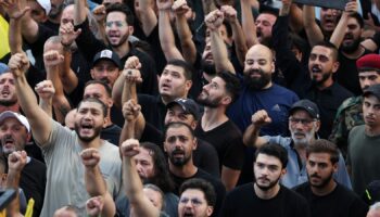 Men react as they attend the funeral for people who were killed amid the detonation of pagers across Lebanon, in Beirut, Lebanon September 18, 2024. REUTERS/Mohamed Azakir