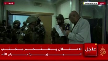 Al Jazeera's bureau chief in Israel and the Palestinian Territories, Walid al-Omari, reads from military order papers that were handed to him by Israeli soldiers at the Al Jazeera office in Ramallah, in the Israeli-occupied West Bank, September 22, 2024 in this screen grab from video. REUTERS TV/Al Jazeera via Reuters THIS IMAGE HAS BEEN SUPPLIED BY A THIRD PARTY. MANDATORY CREDIT. OVERLAYS FROM SOURCE.