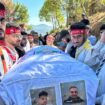 The coffin of a young boy is carried