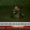 In this image made from a Fox Weather broadcast, meteorologist Bob Van Dillen rescues a woman stuck in floodwaters caused by Hurricane Helene in Atlanta, Friday, Sept. 27, 2024. (Fox Weather via AP)