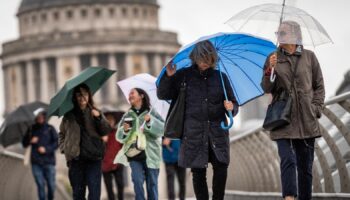 Umbrellas amid wind and rain in London on Friday. Pic: PA