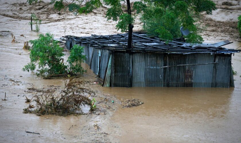 A tin shed lies partially submerged at the edge of the Bagmati River in spate after heavy rains in Kathmandu, Nepal, Saturday, Sept. 28, 2024. (AP Photo/Gopen Rai)