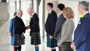 The King shakes hands with First Minister John Swinney. Pic: PA