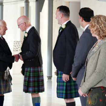 The King shakes hands with First Minister John Swinney. Pic: PA