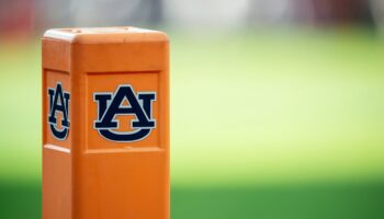 Auburn cheerleader knocks down Oklahoma player running onto field while performing stunts