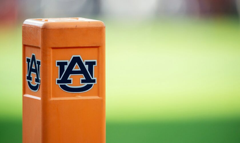 Auburn cheerleader knocks down Oklahoma player running onto field while performing stunts