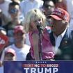 Adorable moment Trump's young granddaughter repeats his famous catchphrase to crowd in North Carolina from behind bulletproof screen - as scandal-hit ally skips rally