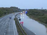 Drivers rescued on M5 after floods leave them stranded in their cars as schools close and roads and railways are left underwater   - latest news