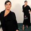 Eva Longoria flaunts her curves in an elegant draped black gown as she attends pal Victoria Beckham's runway show at Paris Fashion Week