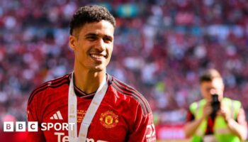 A smiling Raphael Varane at Wembley wearing his FA Cup final winner's medal