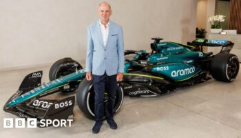 Adrian Newey stands in front of an Aston Martin Formula 1 car