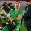 Argentina goalkeeper Emiliano Martinez holds a replica Copa America trophy against his crotch