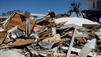 A man who lives in Keaton Beac, works to recover his belongings from his home after Hurricane Helene passed through the Florida panhandle. Pic: Reuters