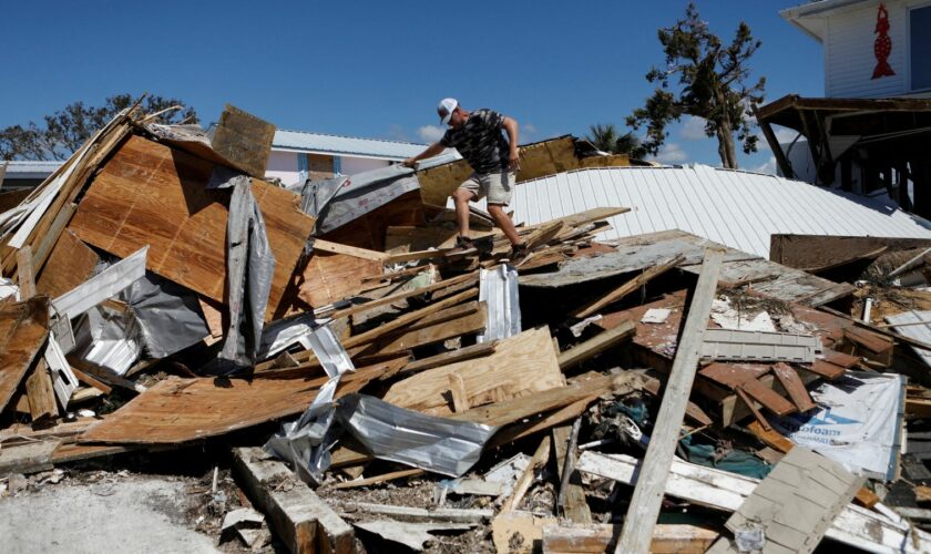 A man who lives in Keaton Beac, works to recover his belongings from his home after Hurricane Helene passed through the Florida panhandle. Pic: Reuters