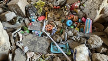 Children's toys in rubble of deadly apartment block strike