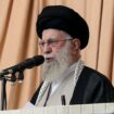 Iran's supreme leader holds rifle as he warns about possible future missile attack