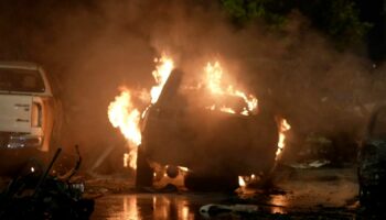 A vehicle is seen on fire at the site of an explosion that caused injures and destroyed vehicles at outside the Karachi airport, Pakistan, Sunday, Oct. 6, 2024. (AP Photo/Mohammad Farooq)