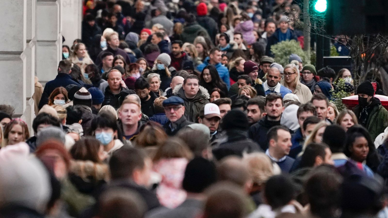 People wear face masks as they walk in Regent Street, in London, Sunday, Nov. 28, 2021. Britain's Prime Minister Boris Johnson said it was necessary to take ...targeted and precautionary measures... after two people tested positive for the new variant in England. He also said mask-wearing in shops and on public transport will be required. (AP Photo/Alberto Pezzali)