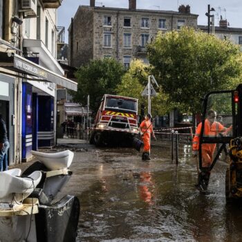 Workers clear mud from the street, in Annonay, central France, on October 18, 2024, the day after the city was stuck by floods.Des agents nettoyent les rues d'Annonay, en Ardèche, au lendemain des inondations qui ont frappé la ville, le 18 octobre 2024