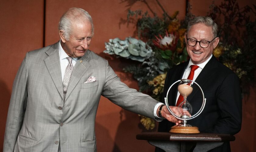 President of the Legislative Council, Ben Franklin (right), watches as King Charles III turns an hourglass he is presenting as a gift to mark the Bicentenary of the New South Wales Legislative Council, during an event marking the anniversary at New South Wales Parliament House, in Sydney, on day one of his visit to Australia and Samoa. The specially commissioned hourglass was handmade at The Goldsmith's Centre, with the wooden base supplied by The King's Foundation from a cedar tree at his Highg