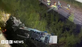 Clear-up continues after lorry falls 60ft off bridge