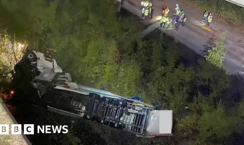 Clear-up continues after lorry falls 60ft off bridge