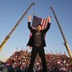 Excited Elon Musk JUMPS on to stage to join Trump in Butler as he reenacts former president's 'fight, fight, fight' moment after getting shot