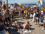 Hundreds of anti-tourist protesters storm Tenerife beach as holidaymakers cower in their towels