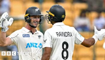 New Zealand batters Will Young and Rachin Ravindra celebrate victory in India